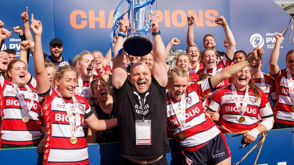 Sean Lynn lifts the PWR trophy with the players