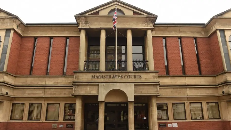 Leicester Magistrates' Court with a Union Jack flag flying above the court sign
