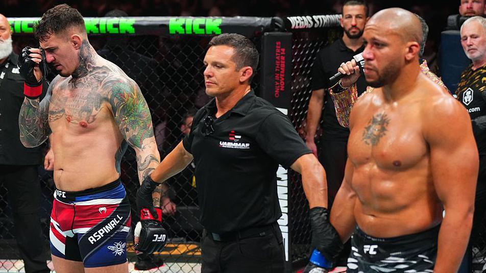 Tom Aspinall holds a cloth to his eye as his fight wth Ciryl Gane is declared a no-contest