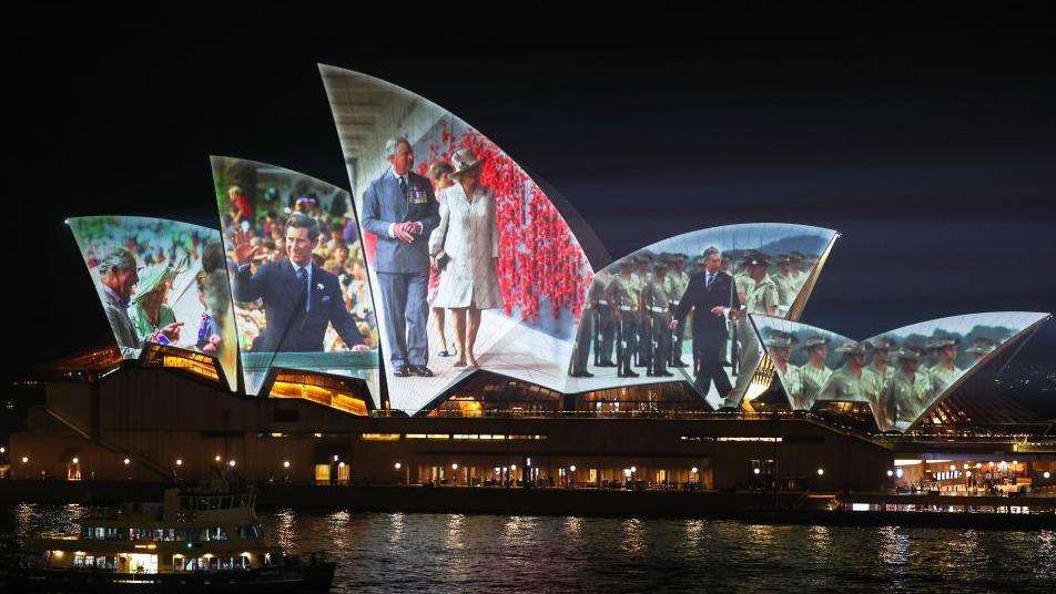 Images from previous royal visits involving the monarch are projected onto the Sydney Opera House.