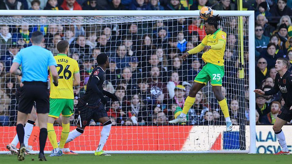 Norwich City player Paris Maghoma heads in the opening goal against West Bromwich Albion.