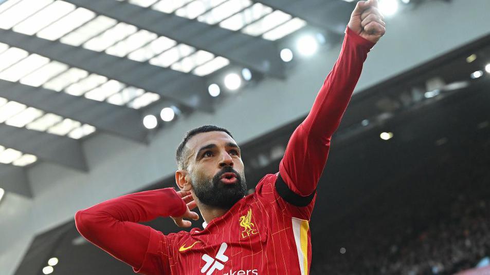 “He Fires A Bow. Now Give Mo His Dough” is the demand from Liverpool's supporters over Salah's new contract