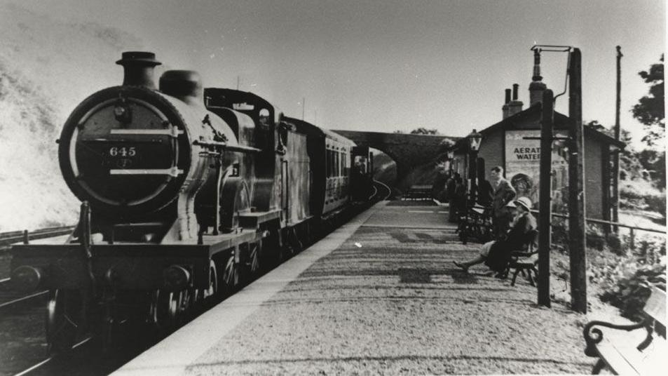 A view of Portpatrick station in black and white with passengers waiting