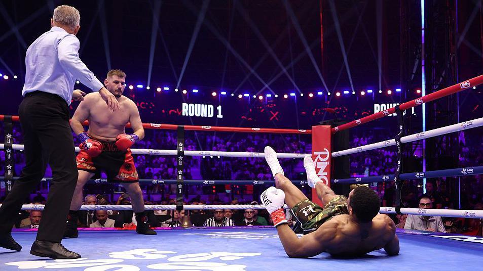 Anthony Joshua on the canvas after being dropped by Kristan Prenga