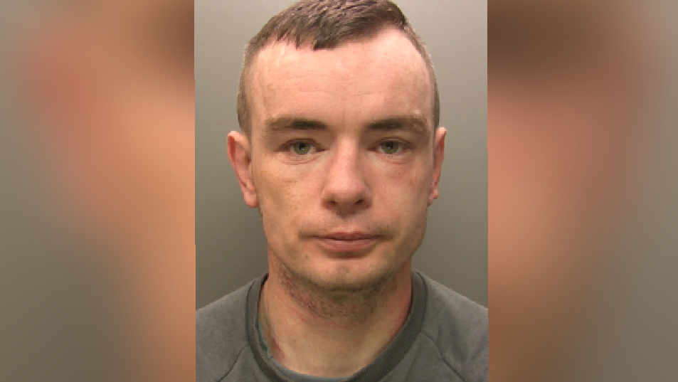 Police mugshot of Kieran Winder, of Hunday Court, Workington, who has been jailed for attacking his ex-partner and helping to break into a property while the owners slept inside. He has brown hair which is combed over to the side and is wearing a serious expression.