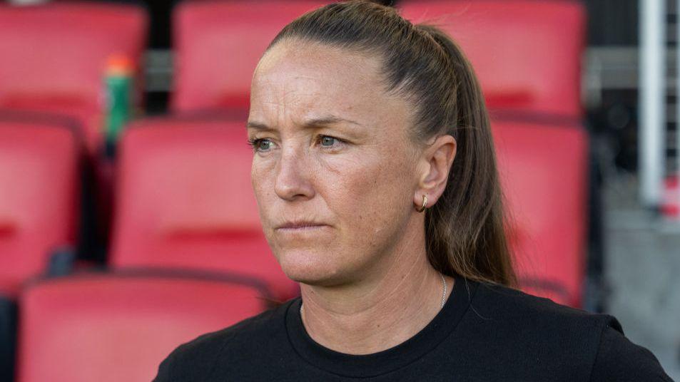 Casey Stoney watches a game during her time as San Diego Wave head coach