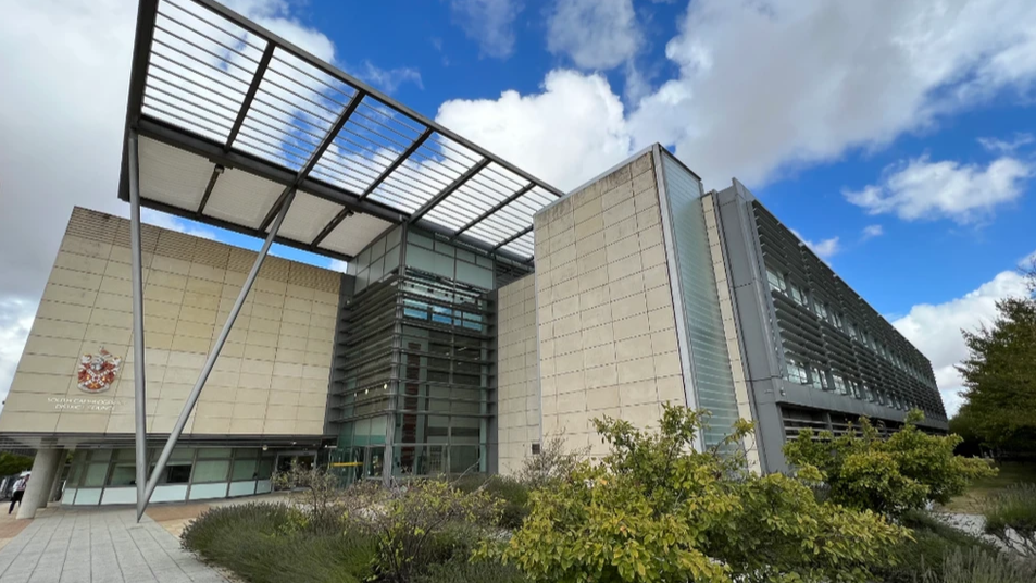 exterior of South Cambs District Council offices taken from a low angle and showing a pale brick building with iron struts