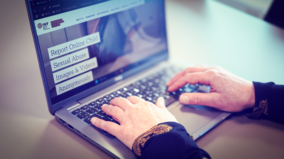 A woman types on a laptop keyboard 