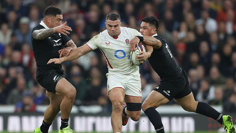England back-row Ben Earl takes on New Zealand defenders during the Test match at Twickenham in November 2025 