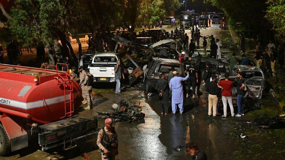 Security officials examine wreckage at the site of the explosion