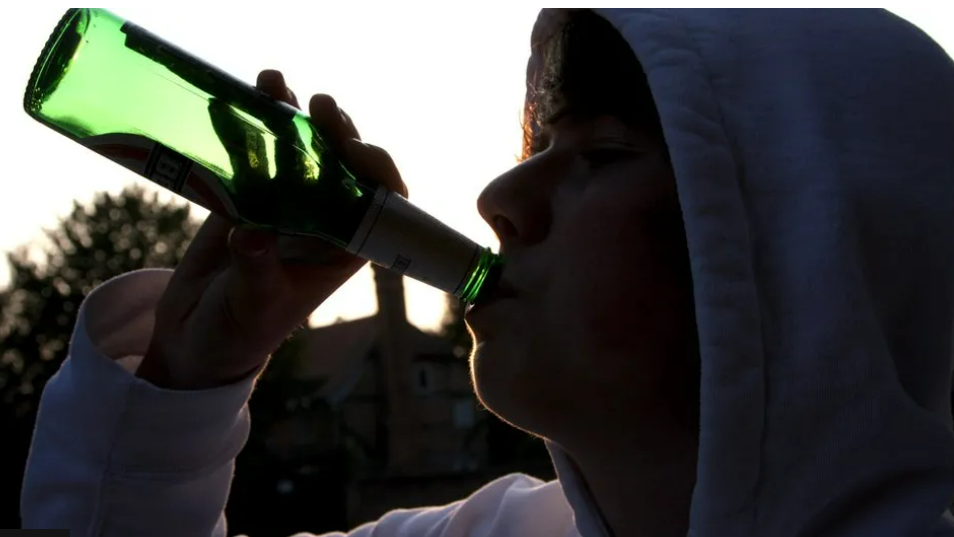 Person drinking outdoors 