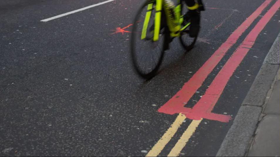 Red route and double yellow lines pictured with a bike (generic image)