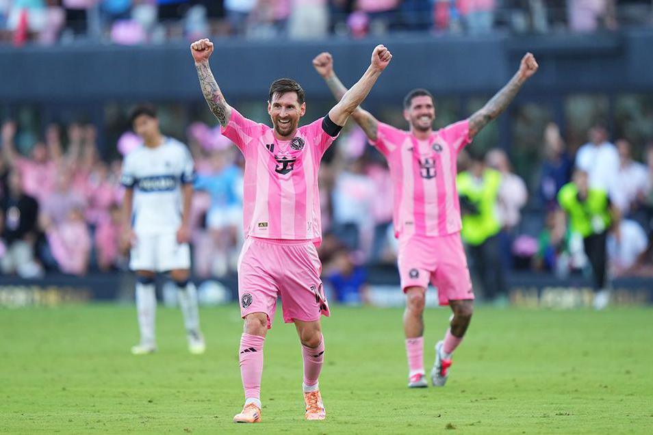 Lionel Messi, in the pink jersey of Inter Miami, raises his arms in celebration after winning the Audi 2025 MLS Cup