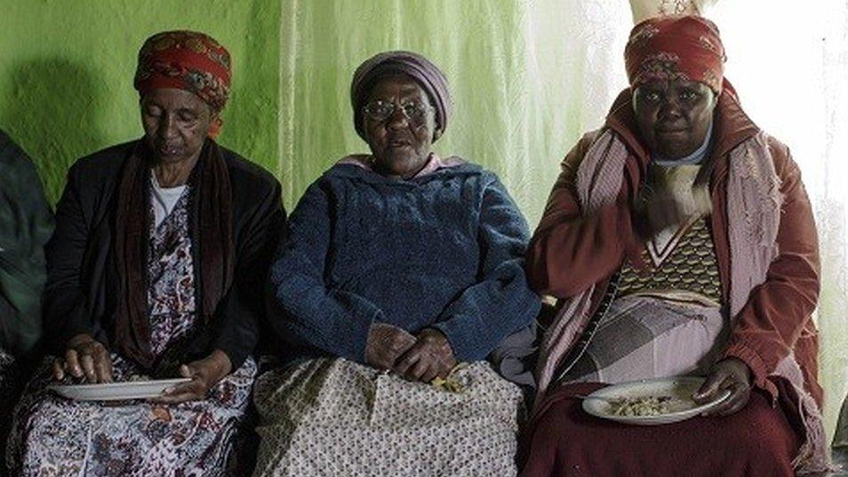 Women sitting for a funeral