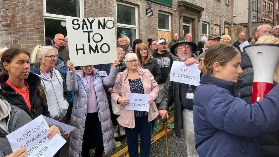 Residents in the Scholes area of Wigan hold a protest, bearing signs that say 'Say No to HMO'