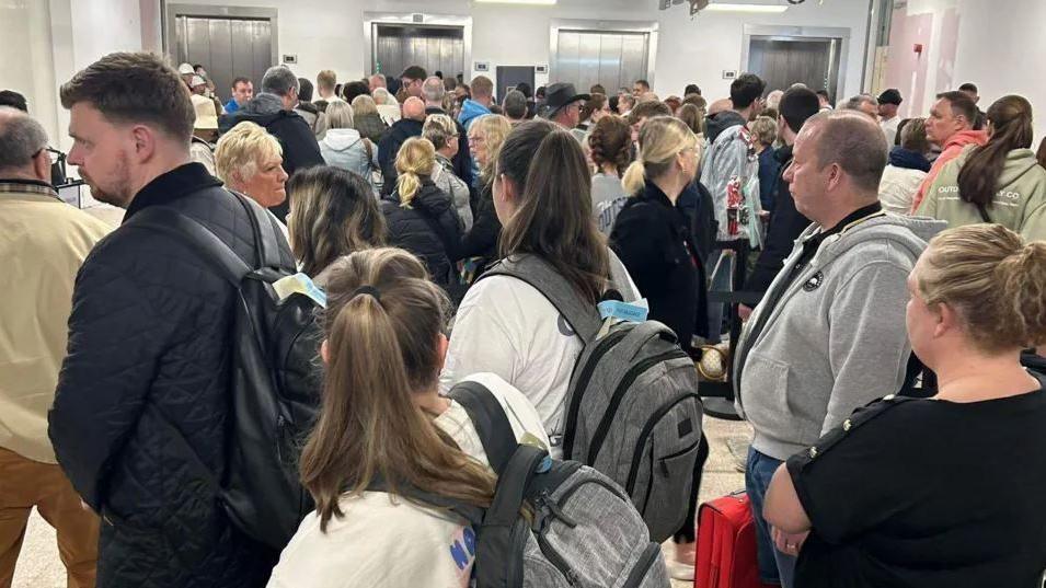 Passengers queueing at Birmingham Airport