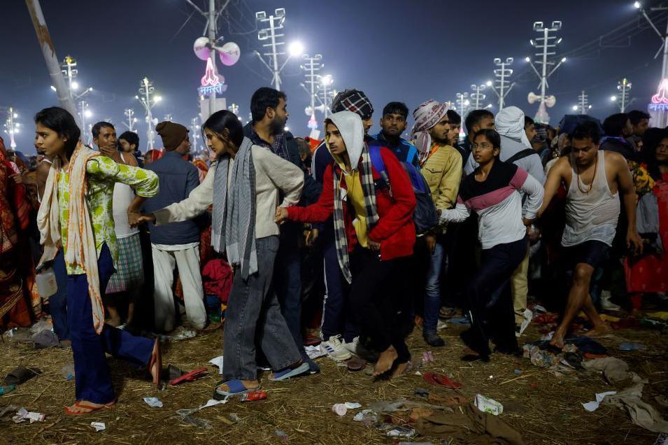 Devotees hold hands as they leave after a stampede before the second "Shahi Snan" (royal bath) at the "Maha Kumbh Mela" or the Great Pitcher Festival, in Prayagraj, India, January 29.