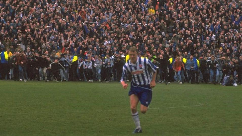 Brighton fans get ready to invade the Goldstone Ground after the last match to be played at Brighton's beloved former home