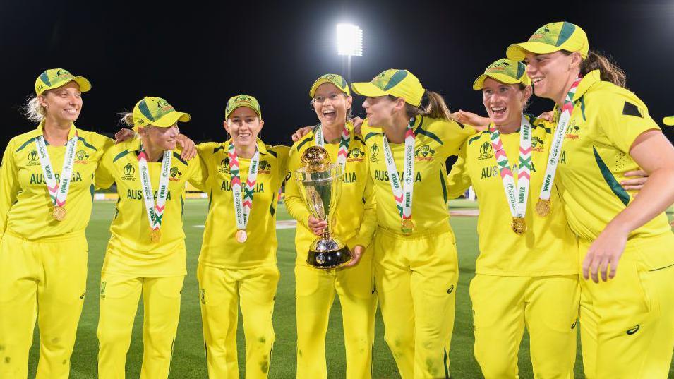 Australia lifting the 2022 World Cup trophy.