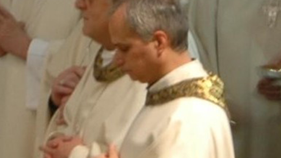 Pope Leo XIV is in gold and white priestly vestment