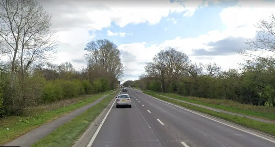 A40 dual carriageway,  with grass verges either side and a few blurred cars in frame.