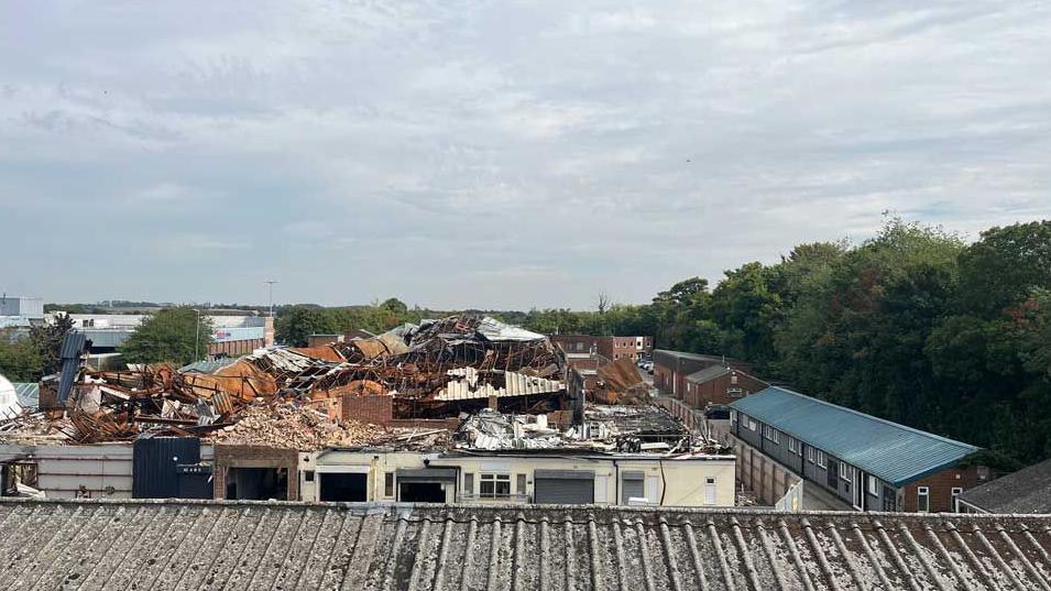 A shot from above of the aftermath of the fire at the Baldock industrial estate. The wreckage of units stretches into the distance.