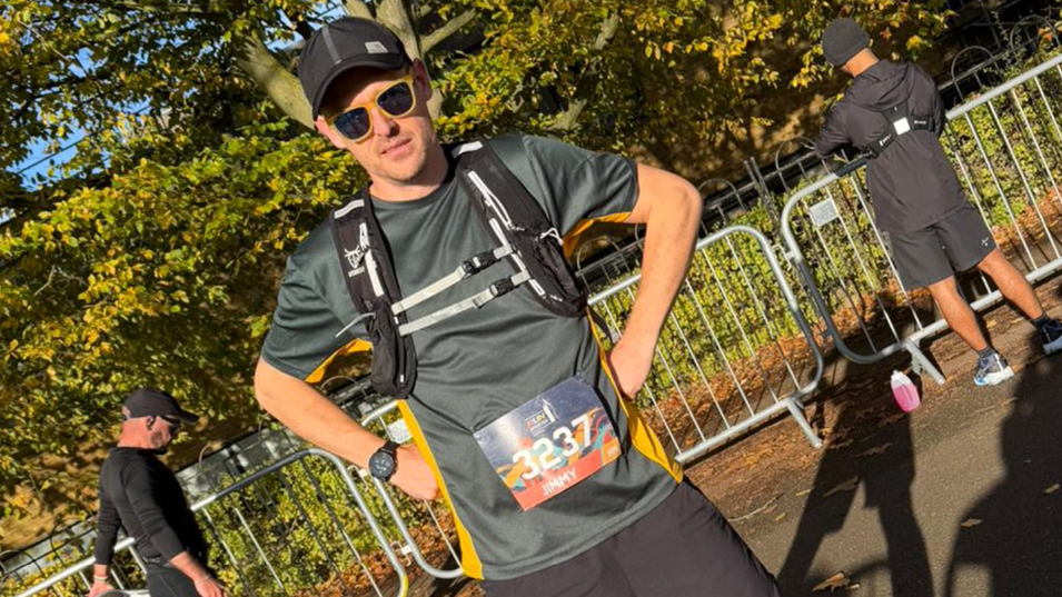 Jimmy Francis wearing a cap, shades and backpack - looking at the camera with his hands on his hips and ready to take part in Leicester's half marathon on Sunday 26 October 2025.