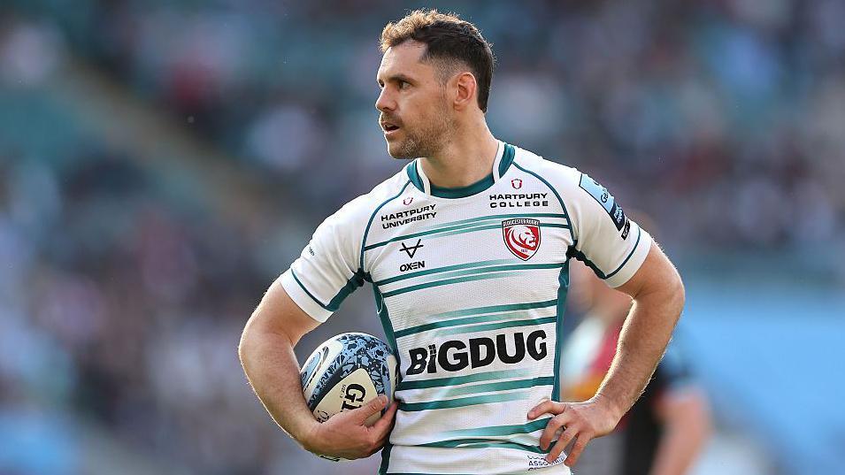 Tomos Williams with a ball under his arm while playing for Gloucester