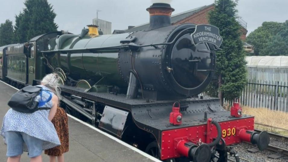 A woman and child look at the The Kidderminster Venturer