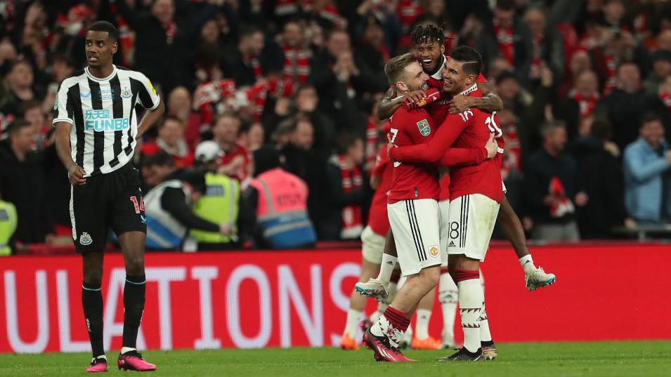 Manchester United players celebrate scoring against Newcastle in the 2023 League Cup final