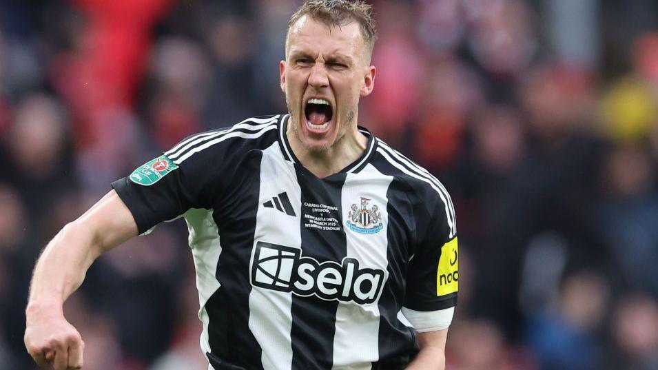 Newcastle United's Dan Burn celebrates after opening the scoring against Liverpool in the Carabao Cup Final at Wembley