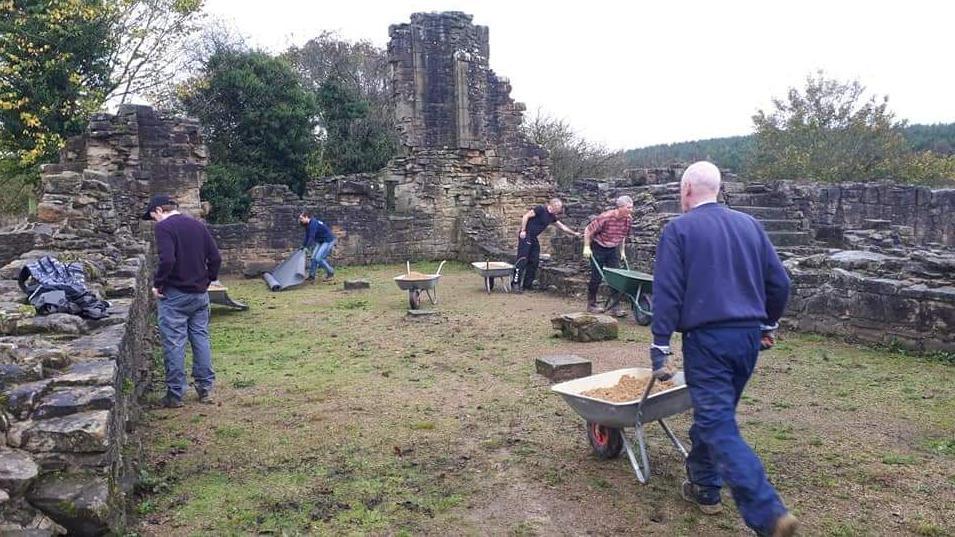 A group of five volunteers working at the manor house.