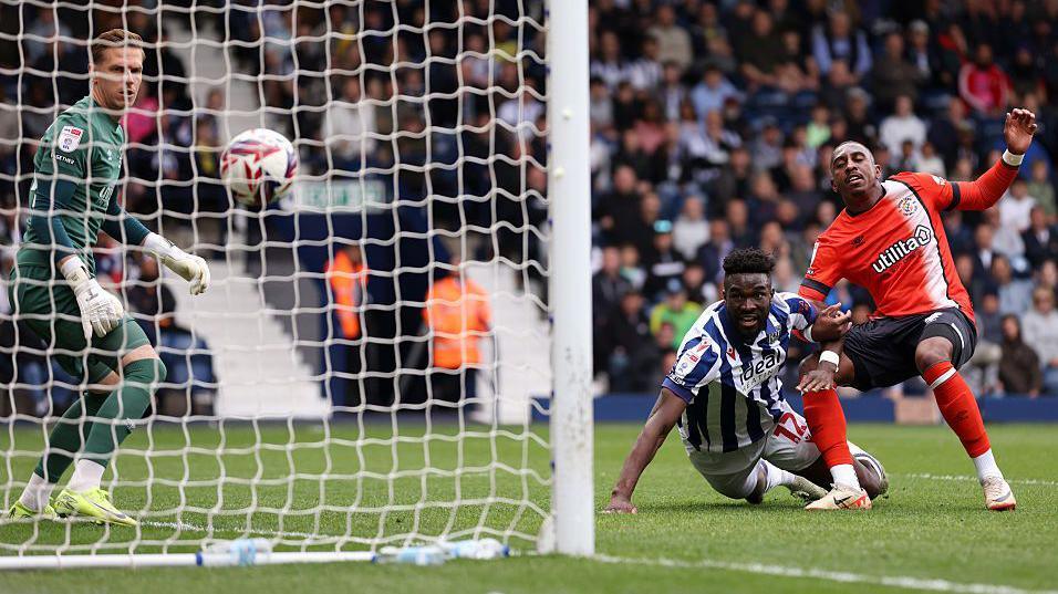 West Bromwich Albion's Daryl Dike hits the ground as he watches his header go into the goal against Luton Town