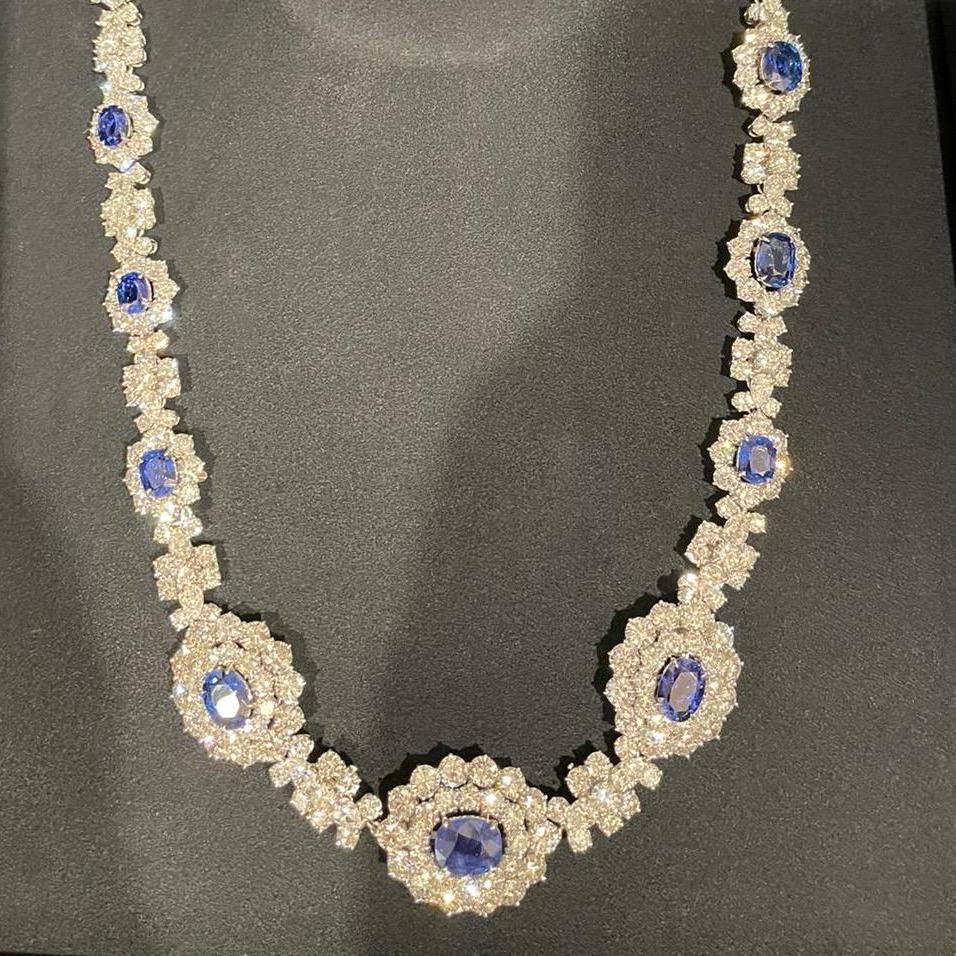 A diamond and sapphire necklace with many diamonds 