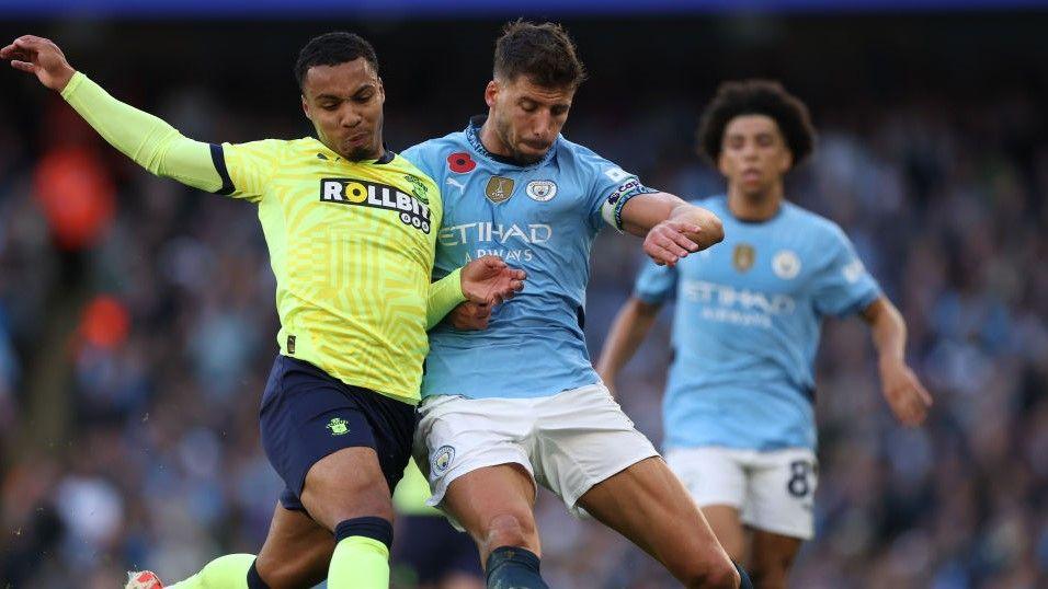 Southampton's Cameron Archer tussles for possession with Manchester City's Ruben Dias