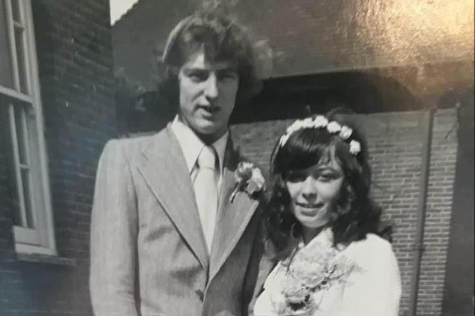 A black and white image of the couple on their wedding day