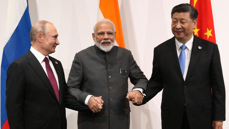 OSAKA, JAPAN - JUNE 28: (RUSSIA OUT) Russian President Vladimir Putin (L), Indian Prime Minister Narendra Modi (C) and Chinese President Xi Jinping (R) pose for a group photo prior to their trilateral meeting at the G20 Osaka Summit 2019 on June 28, 2019 in Osaka, Japan. Vladimir Putin has arrived in Japan to participate in the G20 Osaka Summit and to meet U.S.President Donald Trump. (Photo by Mikhail Svetlov/Getty Images)