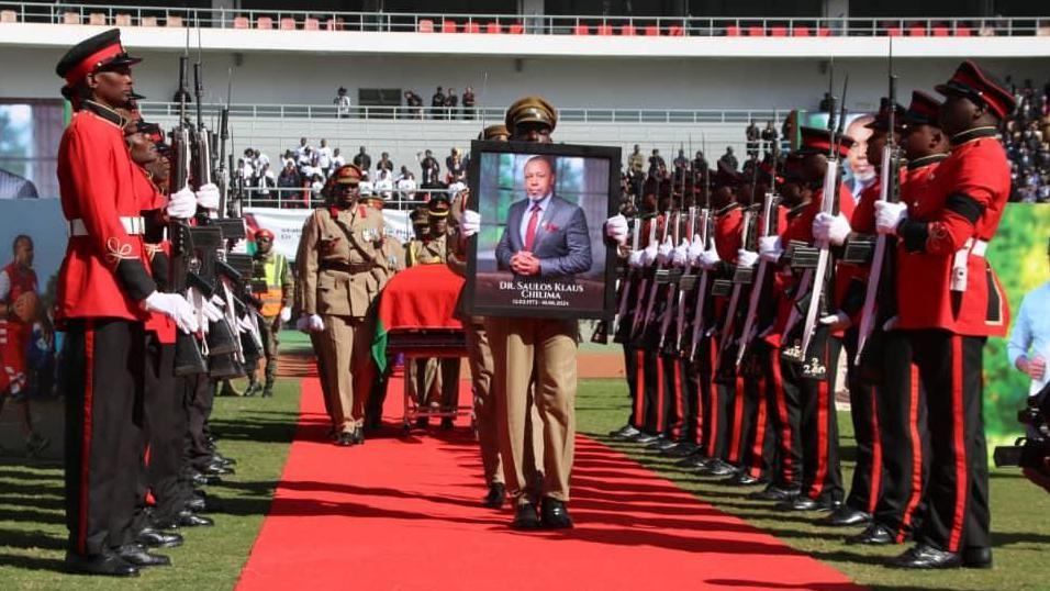 Guard of honour holding a photograph of Saulos Chilima