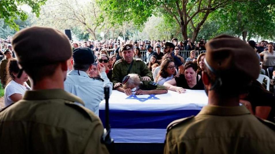 People mourn an Israeli soldier killed in a Hezbollah drone attack during his funeral in northern Israel. Photo: 14 October 2024