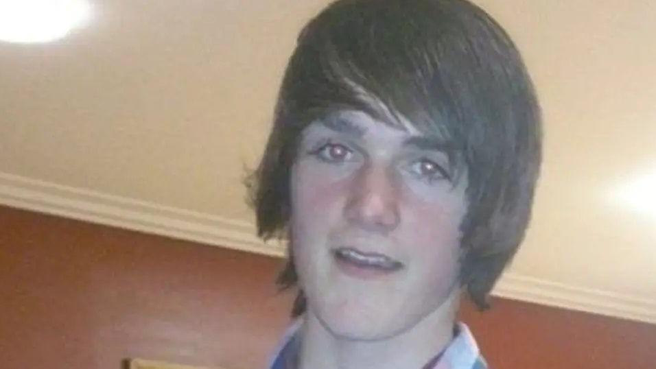 A vintage photo of a teenager with long sweeping hair