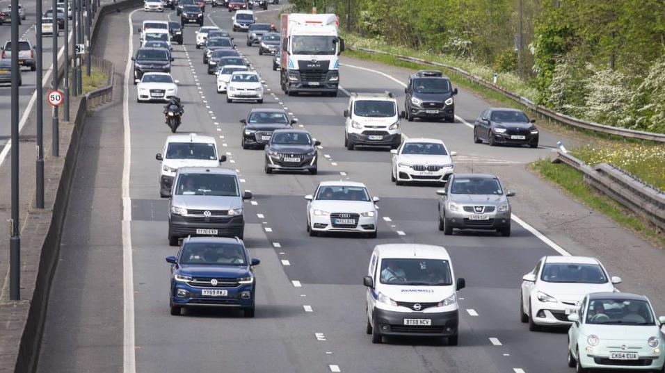 The M4 motorway around Newport, where three is lanes of traffic. There are several vehicles on the three lanes.