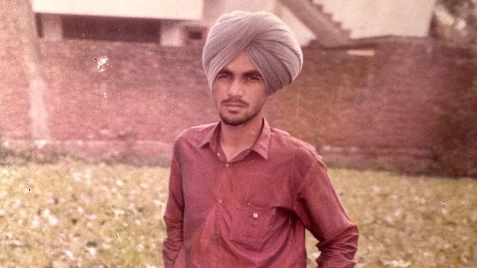 An old photo of Paramjit Singh wearing a red shirt