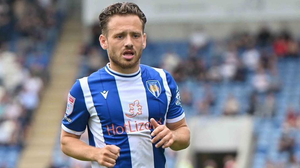 Close up of Jack Payne playing for Colchester United