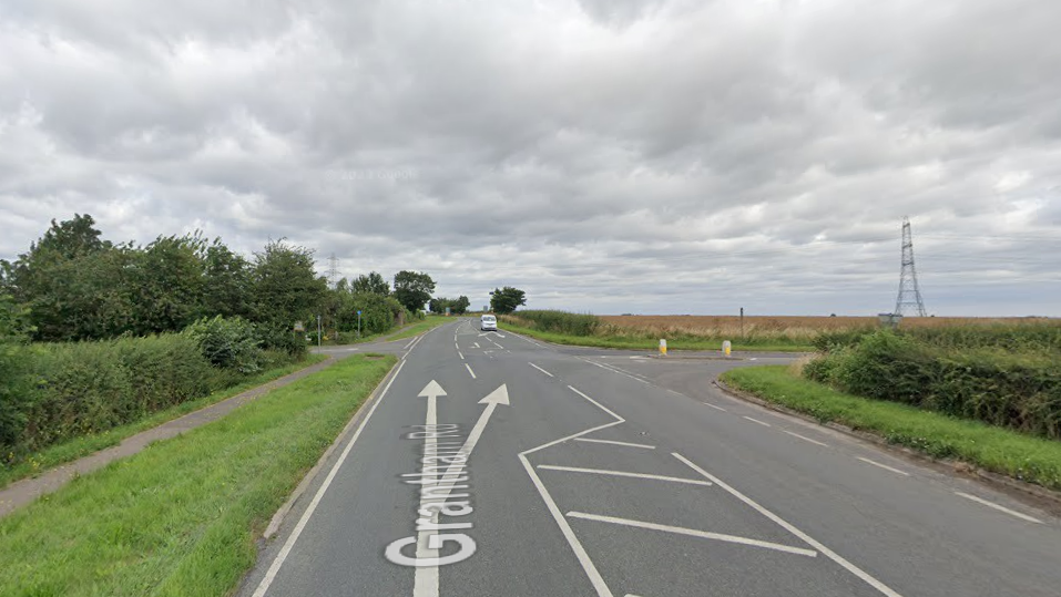 The A607 looking towards the junction with the B1202.  It is a rural area with fields to the right of the road.