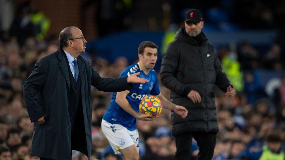 Seamus Coleman goes to take a throw-in as Jurgen Klopp watches on
