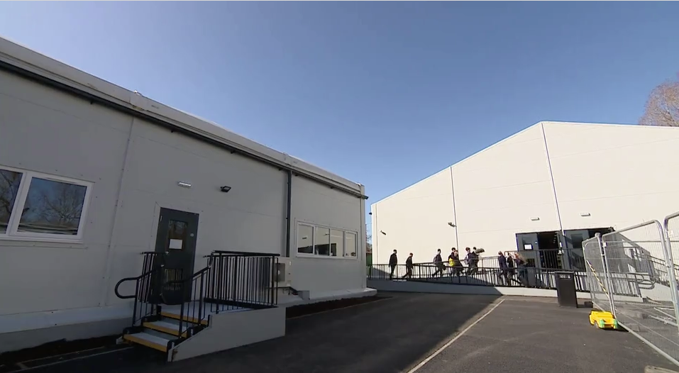 Pupils file into a a building housing temporary classrooms at St Leonard's Catholic High School. 