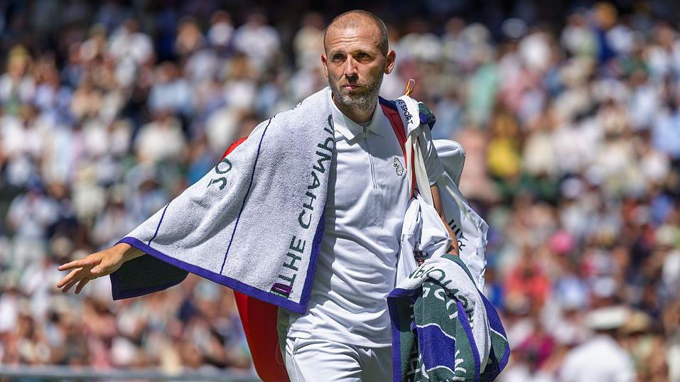 Dan Evans leaves the court after losing to Novak Djokovic at Wimbledon 2025