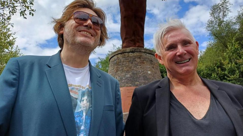 Brothers Nicky Wire and Patrick Jones standing in front of the 20m tall Guardian of the Valleys statue which overlooks the old Six Bells colliery in the south Wales mining town of Abertillery