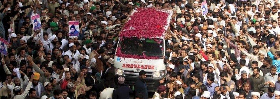 Supporters of Mumtaz Qadri shower rose pastels on an ambulance carrying the body of Qadri for funeral in Rawalpindi, Pakistan, March 1, 2016.