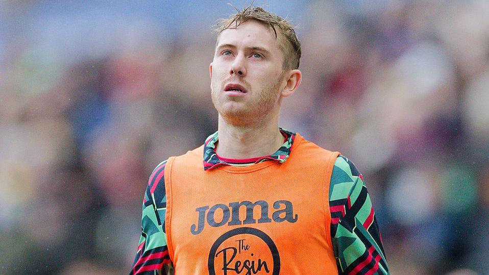 Ollie Cooper warms up before Swansea City's match with Bristol City in January